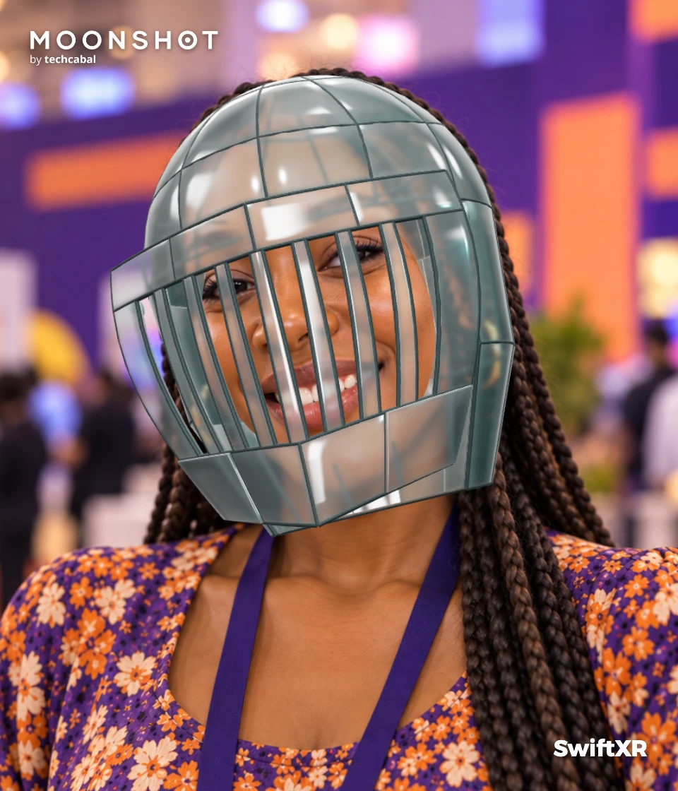 A smiling woman wearing the glass knight helmet, with her face visible through the glass.